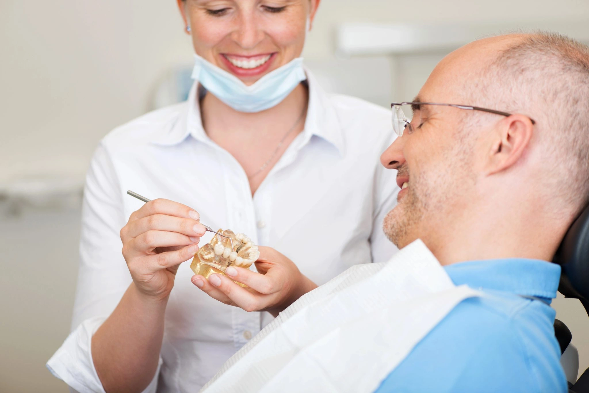 Dental hygienist discussing treatment with a patient during a dental visit