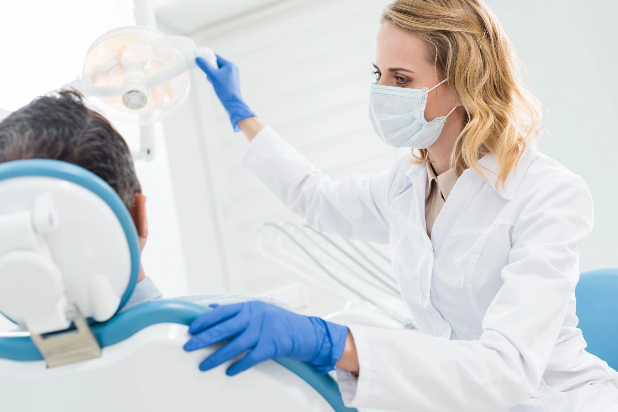 Dental professional preparing fluoride treatment equipment