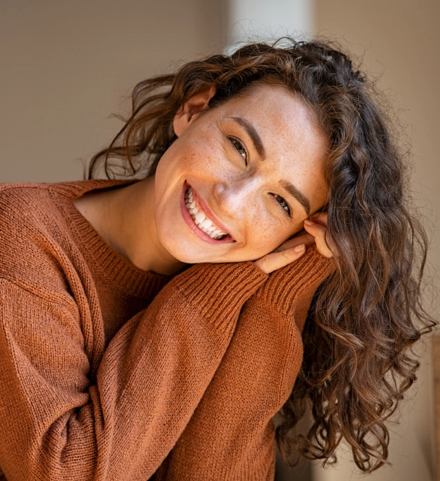 Woman with a bright, confident smile after cosmetic dentistry treatment at Chatfield Smiles in Littleton