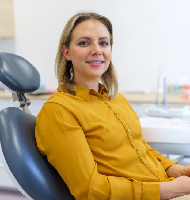 A patient smiling during a routine dental cleaning and exam appointment at Chatfield Smiles in Littleton, CO