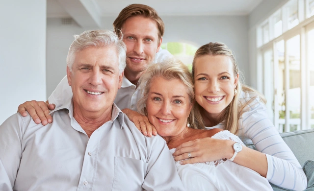 Happy, multi generational family smiling together after receiving personalized family dentistry at Chatfield Smiles in Littleton
