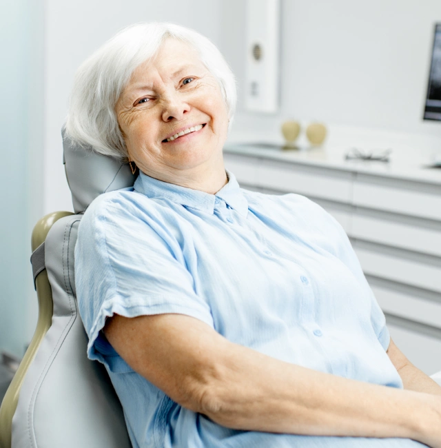A senior patient smiling comfortably after receiving restorative root canal therapy